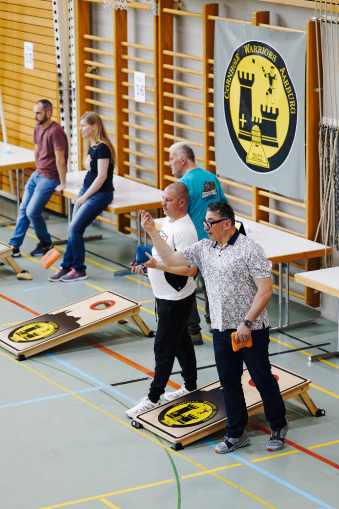 vier Menschen, die Cornhole spielen